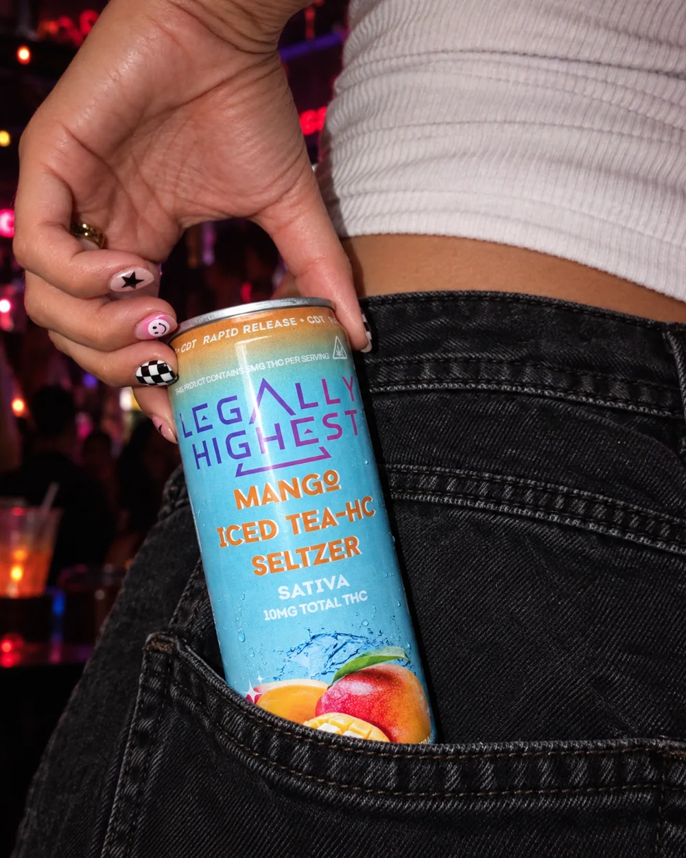 A Mango Iced Tea can tucked in a back pocket at a bar